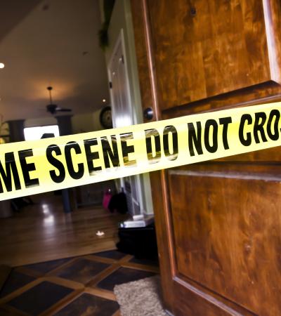 crime scene tape in entryway of residential home