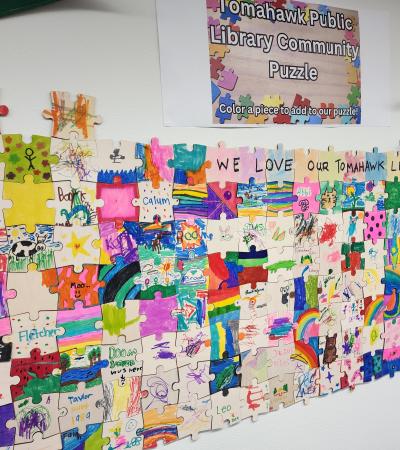 Photograph of the Tomahawk Public Library Community Puzzle on the wall