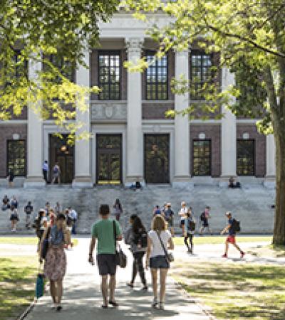 Group of people walking toward a campus building