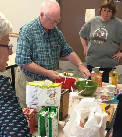 A dietician speaking to people around a table