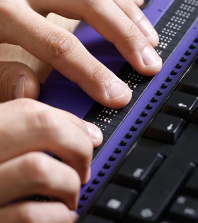 hands communicating on a computer screen reader