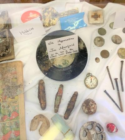 Photograph of display case with time capsule remnants