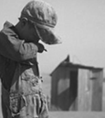 A young boy covers his mouth during a dust storm on farm. Cimarron County, Oklahoma. April 1936.  Arthur Rothstein; The Library of Congress, Prints & Photographs Division