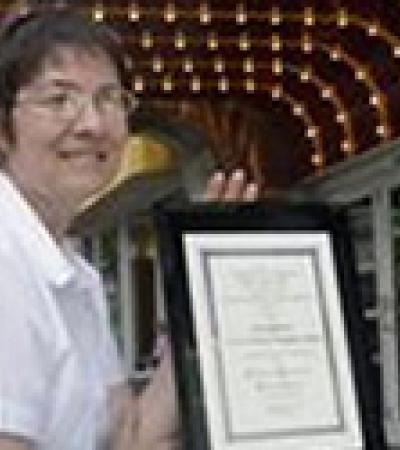 Nicolette Vaillancourt with the Jaffarian Award plaque, under the lights of the York Theater in Elmhurst, Ill.  Sarah Minor