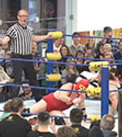 Mondo Lucha wrestlers in the library. Photo credit Sam Gaudet