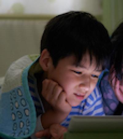 Kids watching a show on an iPad