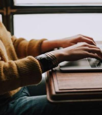 Photo of person working on laptop.