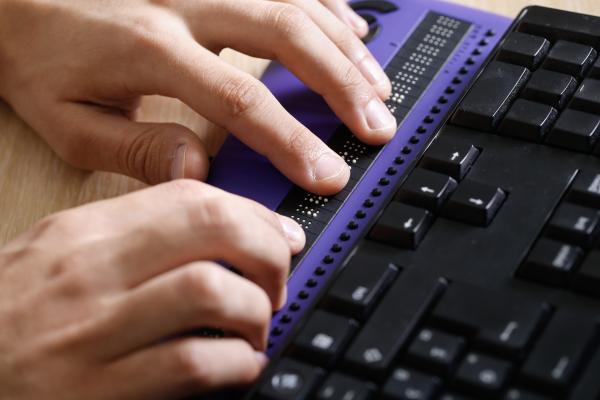 hands communicating with a computer screen reader