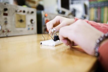 young adult experimenting with electronic equipment