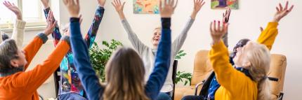 a fun time for support group sitting in a circle with arms thrown up in the air