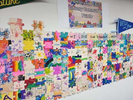 Photograph of the Tomahawk Public Library Community Puzzle on the wall