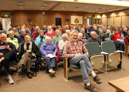 Patrons wait for the lecture to begin.