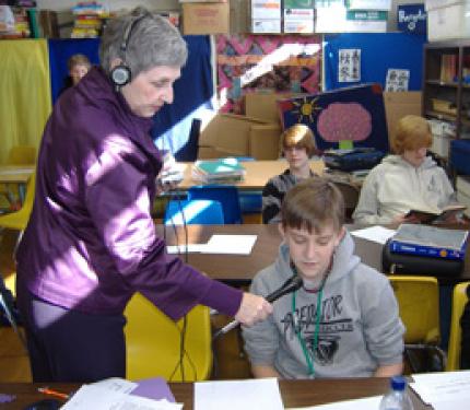 Constance Alexander records eighth-grader Will Smith at Paducah Middle School.