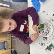 Photograph a child making a Fairy Garden