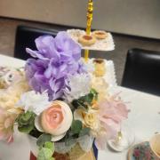 Afternoon tea table setup with biscuits and flowers