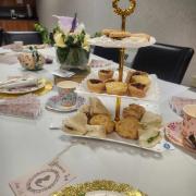 Afternoon tea table setup with tiered baked goods