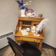 A writing desk decorated with Regency era decor