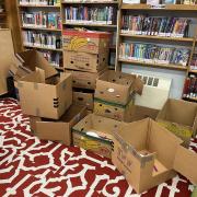 Photograph of cardboard boxes stacked in the library