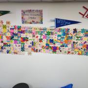 Photograph of the Tomahawk Public Library Community Puzzle on the wall