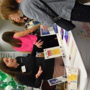 People talking over a table at the Retirement Fair