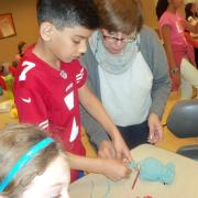 Young boy getting help from teacher