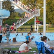 People playing on a slide in a pool