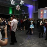 Yule Ball dancers with house points projected on a screen