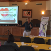 Photograph of presenter presenting in front of slideshow that reads "Your Fiscal Strength"