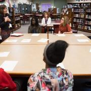 Teens sitting around a table learning how to create poems