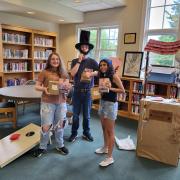 Three program participants pose with their winnings.