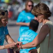 Guest arrives and checks into the event, getting her wristband