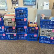 Photograph of stacked milk crates full of puzzle boxes