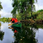 Photograph of two people canoeing in a river