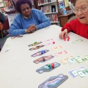 Participants playing a board game 