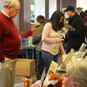 Local Author Fair patrons visiting tables