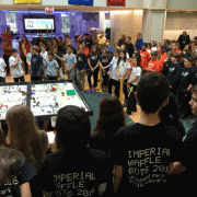 Kids crowded around a FLL table