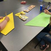 Photograph of participants sketching out panel art