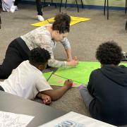 Photograph of participants sketching out panel art