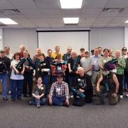 Group of people holding telescopes