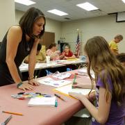 Teens and adults creating street art 