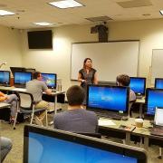 Students at computers listening to presenter 