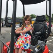 Girl in construction vehicle