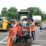 Father and son checking out a construction truck