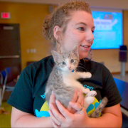 Project Purr volunteer handling kitten