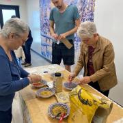 People creating a spice mix.