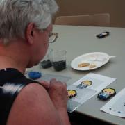 Attendee making a Perler bead Sherlock magnet 