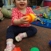 Child playing with stacking cups