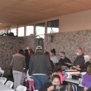 Photograph of program participants serving food and eating.