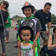 Boys in hats from the Fire Department 