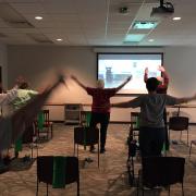 senior citizens doing a dumbbell exercise